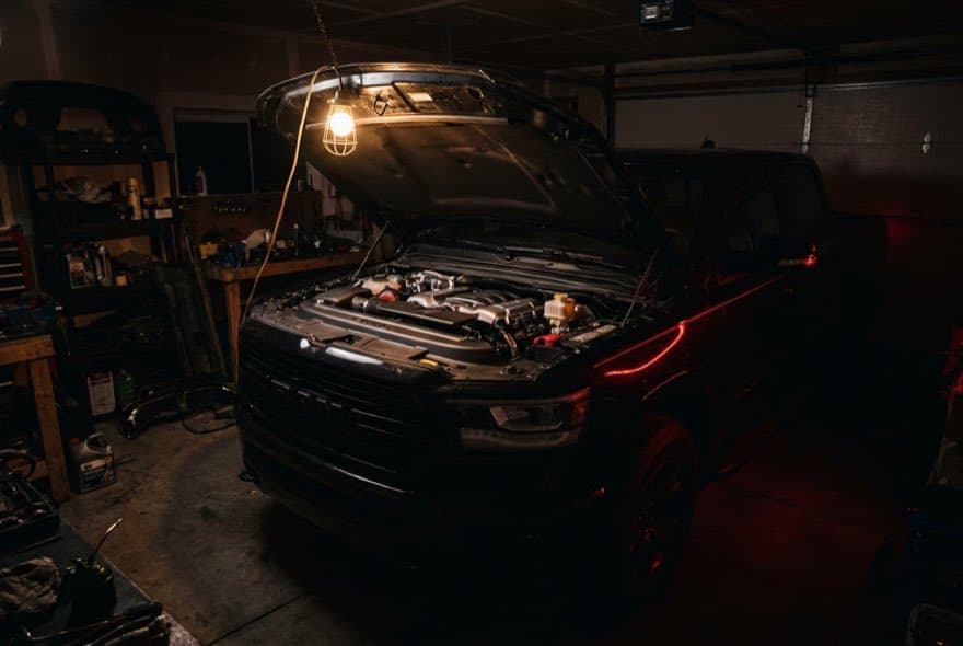 Pickup truck engine bay under a work light